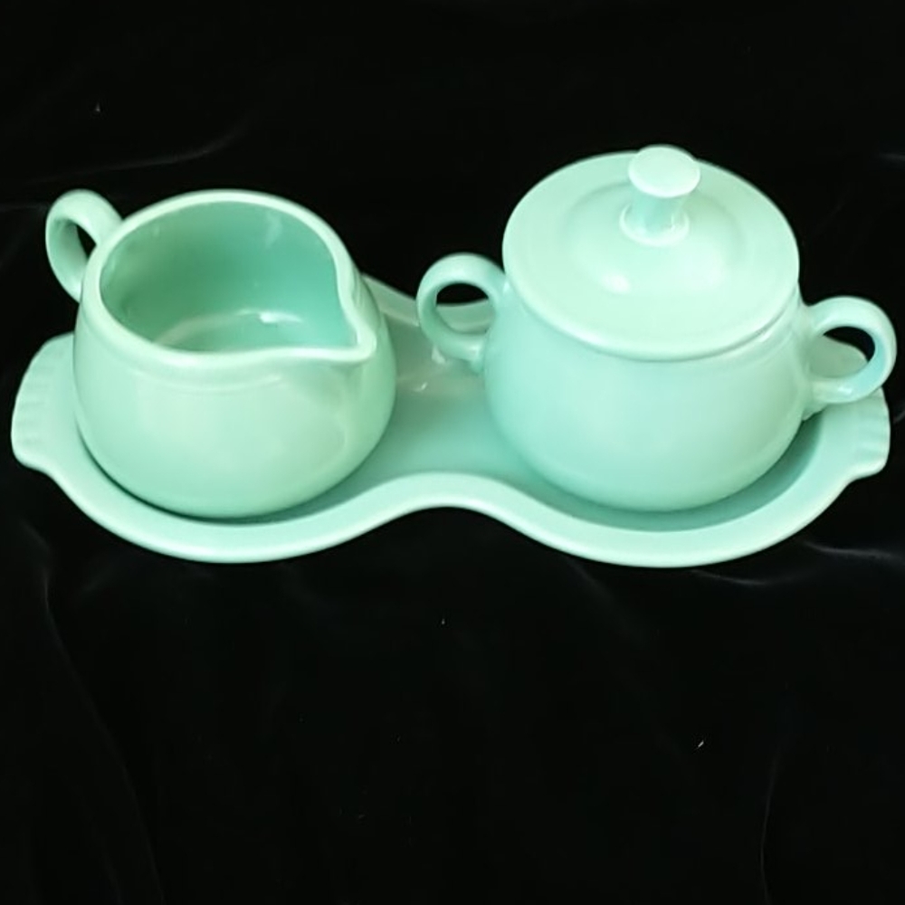Fiestaware creamer and covered sugar bowl